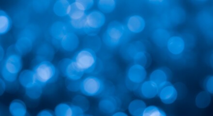 Fototapeta premium A captivating abstract background showcasing soft, ethereal blue bokeh lights. This serene and tranquil composition features numerous out-of-focus circular light elements against a deeper blue backdro