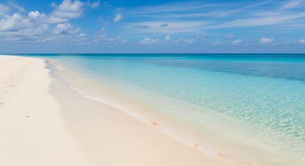 Fototapeta premium A pristine tropical beach showcases soft white sand meeting crystal-clear turquoise ocean waters under a brilliant blue sky. Gentle waves create an idyllic, tranquil atmosphere, perfect for themes of 