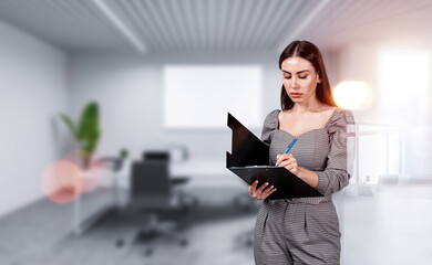 Fototapeta premium Woman writing on clipboard in contemporary office, realistic style, blurred background with lens flare, concept of planning and creative workflow