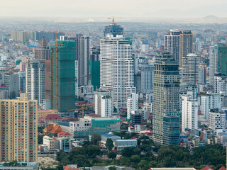 Fototapeta premium Top view aerial of Phnom Penh capital with development buildings, transportation, energy power infrastructure. Famous tourist city of Vietnam, sharing the border with ThaiLand