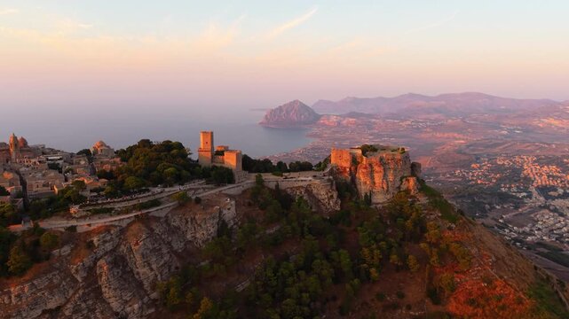 Ancient Castle Of Venus In Mount Erice With Coastal Towns, Mount Cofano, And Tyrrhenian Sea At Sunset In The Background In Sicily, Italy.