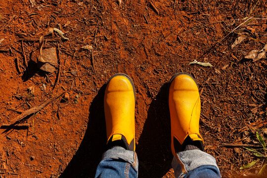 bright yellow rubber boots in dry orange dirt in rural Australia
