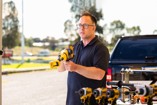 middle aged man giving tool demonstration talk about using equipment safe tool and work practices