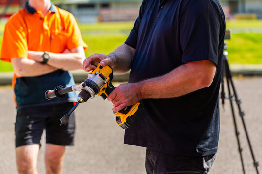 man holding drill tool during trainings session demonstration for young trade apprentices