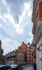 London - 06 25 2022: Plane passes over Kensington Ct