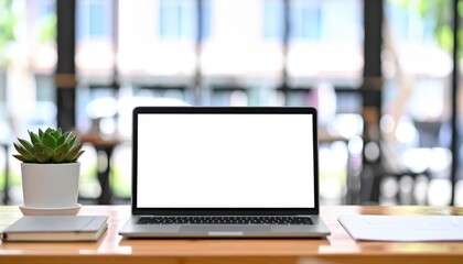 Modern laptop with a blank mockup screen sitting on a wooden desk in a bright office space