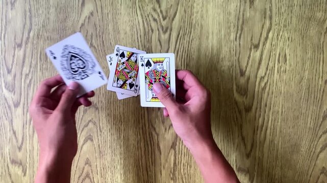 Hands playing cards for fun hobby and engaging leisure time activity.