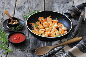 rosemary and garlic seared shrimps in a skillet