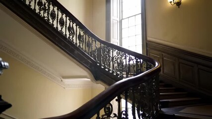 Elegant Curved Wooden Staircase in a Historic Mansion Interior. - Powered by Adobe