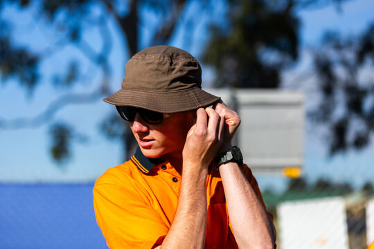 Trade apprentice at worksite putting in earplug for hearing protection safety