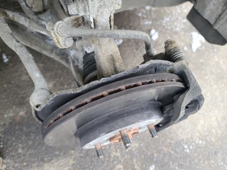 Car without wheel and lift up by hydraulic, waiting for tire replacement