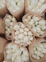 Lot of multicolored tulips bouquets. Flower market or store