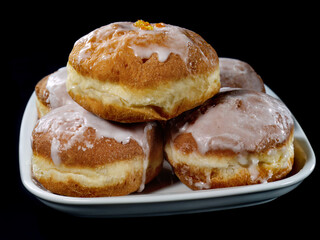 Polish donuts with icing over black background