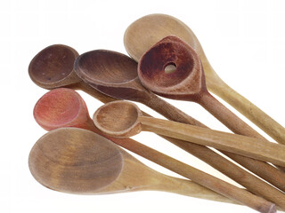 Assorted wooden spoons over white background