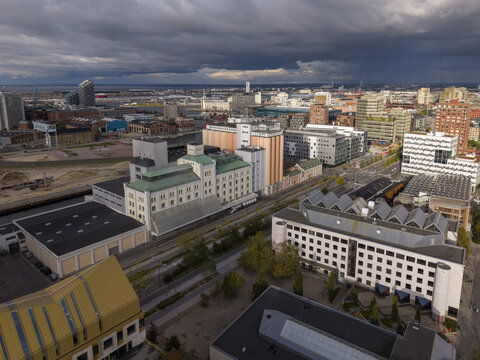 Aerial view of buildings with a mixture of modern and classical architecture under a dramatic sky near the Turning Torso, Malmo, Scania County, Sweden.