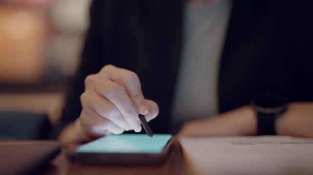 Close up hand of woman working with stylus pen on smartphone in modern business environment.
