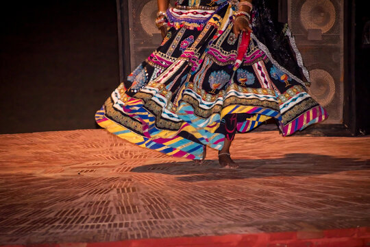 Beautiful Rajasthani dance costume, dancer rotating the lehanga or ghaghra. vibrant Indian culture, grace, and balance, showcasing the colorful attire and art of Rajasthan