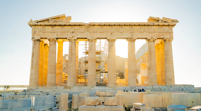 The Parthenon temple on the Acropolis in Athens, Greece, photographed during golden hour. Warm sunlight highlights the ancient marble columns and fine details of the classical architecture