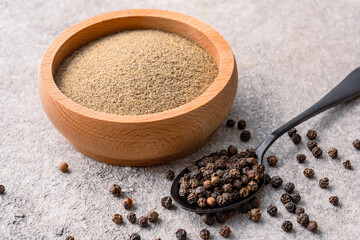  Black peppercorns on white stone table background