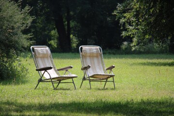 Serene Grass Deck with Two Cozy Chairs for Leisure Moments in a Lush Garden Setting