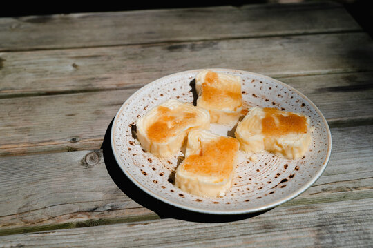 Traditional Slovenian dessert strukli served on plate in restaurant. Having warm cheese strukli for lunch. Struklji - traditional Slovene dish composed of dough and various types of filling.