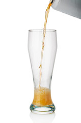 Beer flowing from  tin can into  glass on white background
