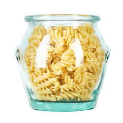 Raw pasta Fusilli in a glass jar isolated on white background. Raw and Dry Macaroni. Italian Culture. Top view.