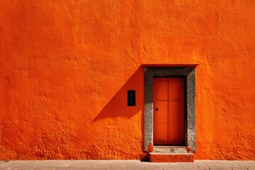 Fototapeta premium Vibrant Orange Wall of a Traditional House in San Miguel de Allende, Mexico - A Colorful Architectural Background