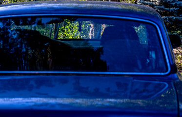 The rear window of an old car.