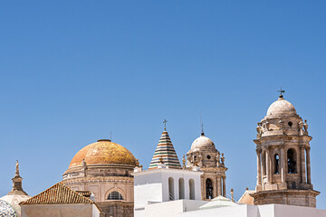 Naklejka premium The roof and towers of the Catedral de Cádiz, the Cathedral in the city of Cadiz, on the coast of Spain. 