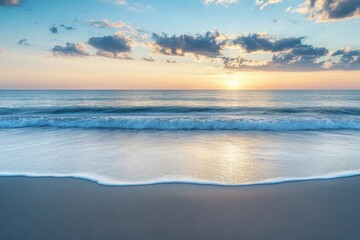 Obraz premium Breathtaking sunset over the calm ocean waves at a serene beach location