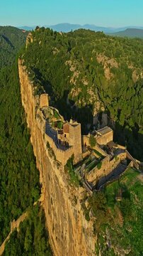  Mornas Fortress stands majestically on top of a rocky cliff. The Fortress of Mornas is a medieval fortress above the village of the same name in the French department of Vaucluse