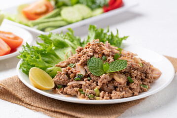 Local Thai food, Spicy minced pork salad (Larb Moo) eating with fresh vegetables