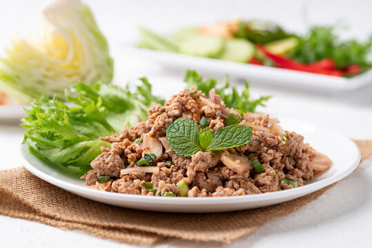 Local Thai food, Spicy minced pork salad (Larb Moo) eating with fresh vegetables 