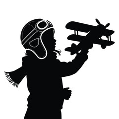 Child silhouette wearing pilot hat plays with toy airplane