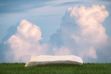 Surreal stone podium with green grass pink white clouds on blue sky nature forest background.Product present natural placement pedestal minimal display,paradise dreamy concept.