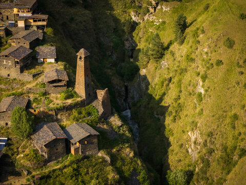 Aerial view of ancient stone structures and watchtowers clinging to the rugged, sun-drenched cliffs of Dartlo, a timeless fortress village, Dartlo, Kakheti, Georgia.