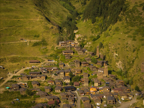 Aerial view of an ancient village nestled amidst verdant hills, where stone towers pierce the sky, Dartlo, Kakheti, Georgia.