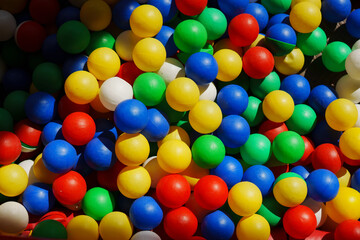 Colorful balls in a vibrant play area during sunny outdoor playtime