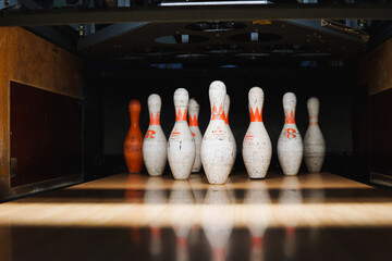 Bowling pins set up for a game in a bowling alley during evening hours