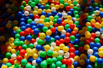 Colorful plastic balls scattered on the ground in a playful setting