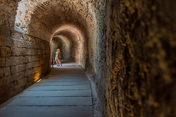 Mom and daughter, on summer vacation, in Spain, in the underground section of the Teatro Romano de Cádiz or Roman Theater of Cádiz.   © Bryan