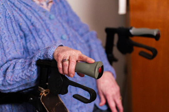elderly Australian woman with walker mobility aid in bedroom at home