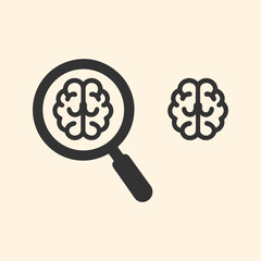 Magnifying glass focuses on brain symbol revealing cognitive processes and knowledge discovery
