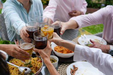 Group of people, family or friends, cheering with glasses of dri