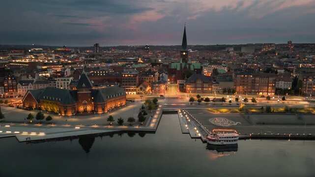 Aerial view of stunning skyline of Aarhus during sunset as the city lights twinkle. Evening shot of Aarhus embankment, Denmark