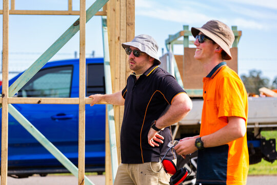 Trade instructor teaching students during hands on learning course building frame of ticket booth