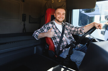 Truck driver smiling giving thumbs up in cabin