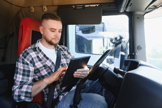 Truck driver using digital tablet inside cabin