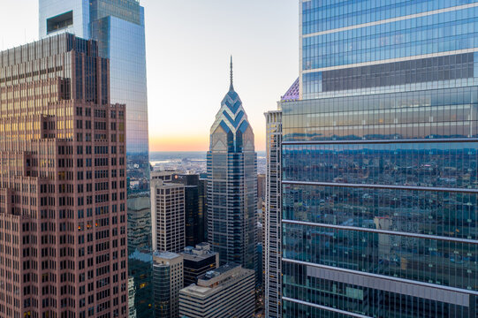 Aerial view of the iconic, soaring Comcast Technology Center piercing the skyline amidst a vibrant cityscape, Philadelphia, Pennsylvania, United States.